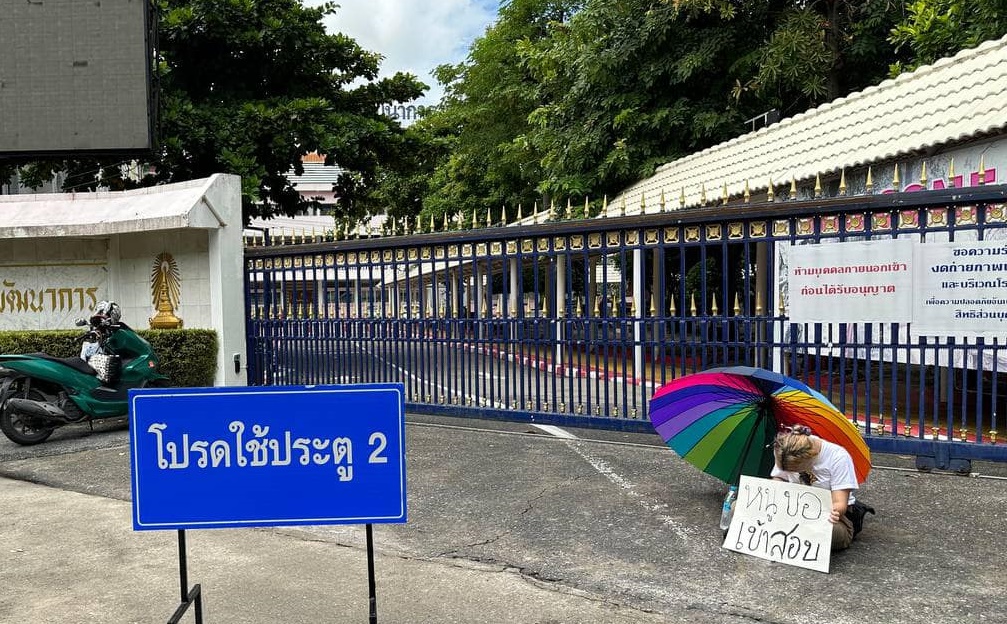 "หยก" ถือป้าย-กางร่มนั่งกลางสายฝน หน้าประตูโรงเรียนเตรียมพัฒน์ ขอเข้าสอบ