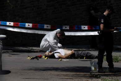เจ้าหน้าที่เซอร์เบียชันสูตรร่างชายคนร้ายที่ใช้หน้าไม้ยิงตำรวจ ก่อนถูกยิงสวนจนเสียชีวิต (Photo : AFP)